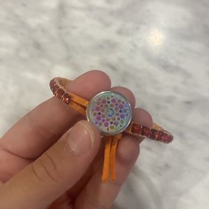I’m selling an orange, kids size bracelet.